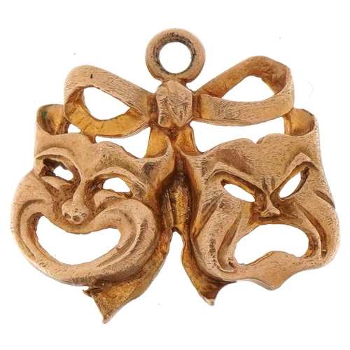 3162 - 9ct gold charm in the form of theatre masks, 1.7cm wide, 1.9g