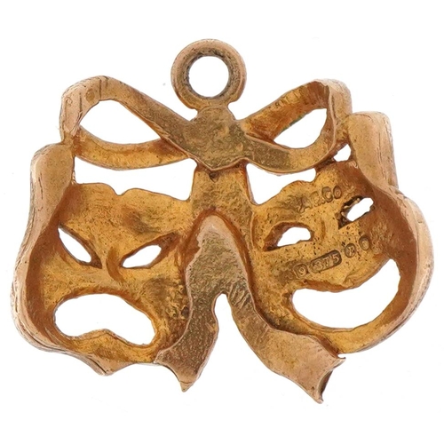 3162 - 9ct gold charm in the form of theatre masks, 1.7cm wide, 1.9g