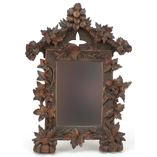 286 - Early 20th century Black Forest carved wood picture frame with later inset mirror having a strut bac... 