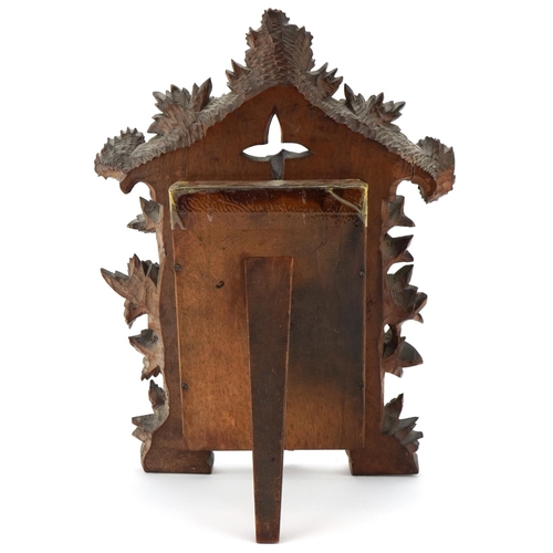 286 - Early 20th century Black Forest carved wood picture frame with later inset mirror having a strut bac... 