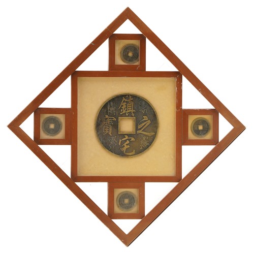 2248 - Framed large Chinese coin and four smaller Chinese coins, the large coin 12.7cm in diameter