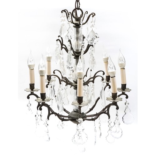 1111 - Bronzed metal eight branch chandelier with cut glass drops, 65cm high x 50cm in diameter