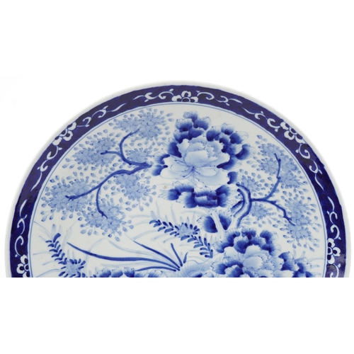 303 - A large Japanese blue and white porcelain charger, early 20th century, with hand painted decoration,... 