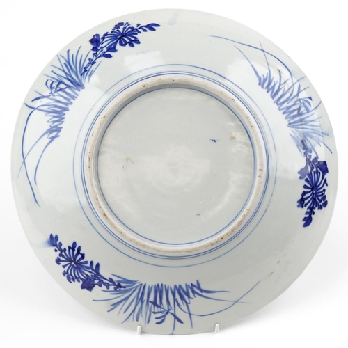 303 - A large Japanese blue and white porcelain charger, early 20th century, with hand painted decoration,... 