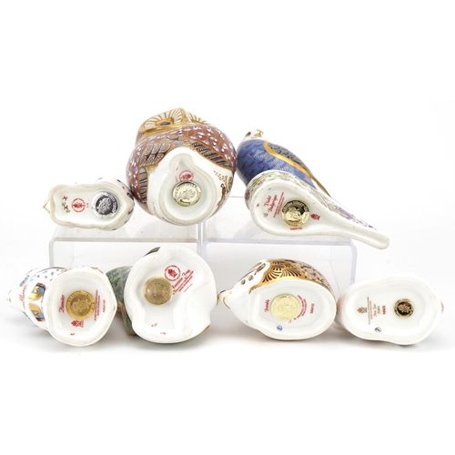 1173 - Seven Royal Crown Derby animal paperweights with stoppers comprising Violet Budgerigar, Owl, New Yea... 