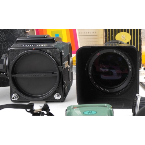 524 - A Hasselblad 2000 FC camera with lenses, accessories and other camera accessories, some with boxes (... 