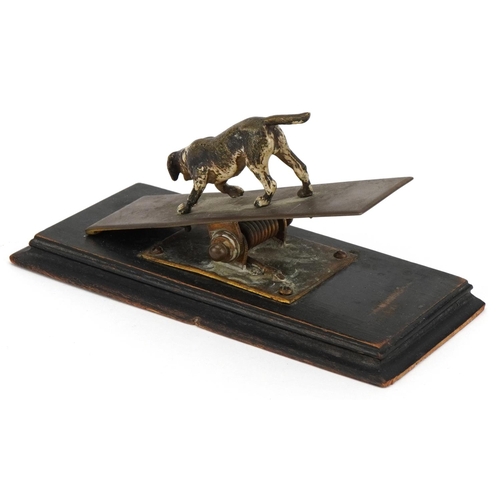 8 - An antique letter clip mounted with a cold painted bronze dog, overall 15.5cm in length.