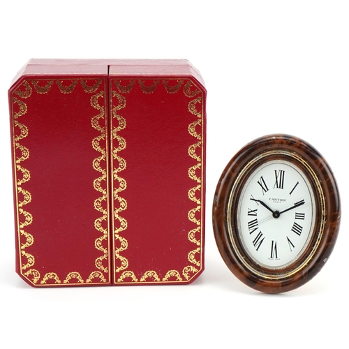  A Cartier enamelled strut clock with tooled leather Cartier box, numbered 7509 11534, 9cm high.