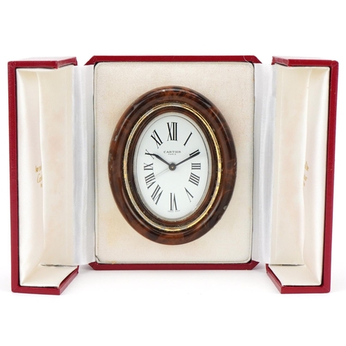  A Cartier enamelled strut clock with tooled leather Cartier box, numbered 7509 11534, 9cm high.