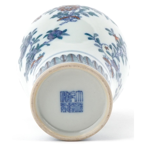 316 - A Chinese porcelain baluster vase hand painted with flowers, character marks to the base, 15cm high.