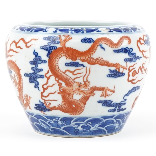 320 - A Chinese porcelain jardinière hand painted with dragons amongst clouds, character marks to the base... 