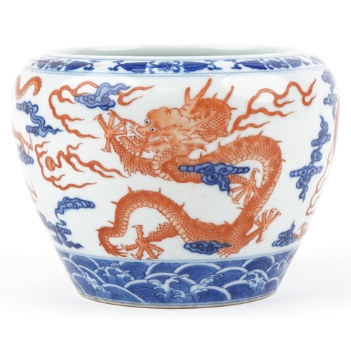 320 - A Chinese porcelain jardinière hand painted with dragons amongst clouds, character marks to the base... 