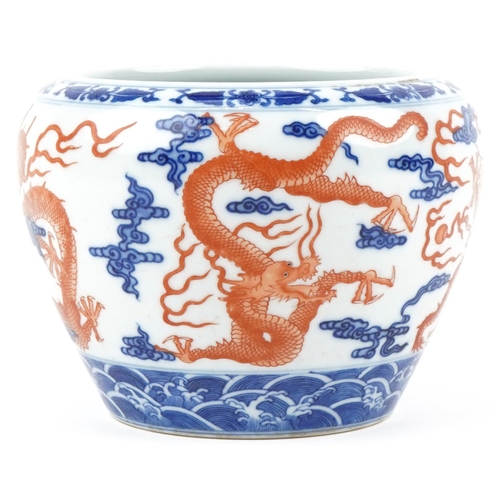 320 - A Chinese porcelain jardinière hand painted with dragons amongst clouds, character marks to the base... 