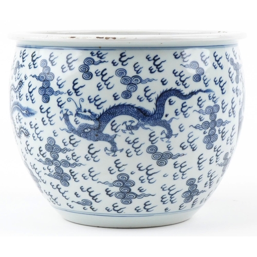 180 - A Chinese blue and white porcelain jardinière hand painted with dragons and phoenixes amongst clouds... 