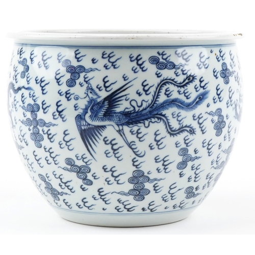 180 - A Chinese blue and white porcelain jardinière hand painted with dragons and phoenixes amongst clouds... 