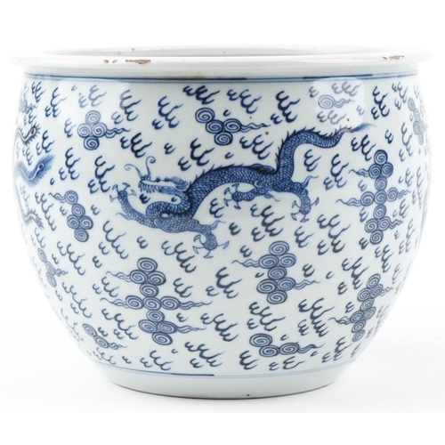 180 - A Chinese blue and white porcelain jardinière hand painted with dragons and phoenixes amongst clouds... 