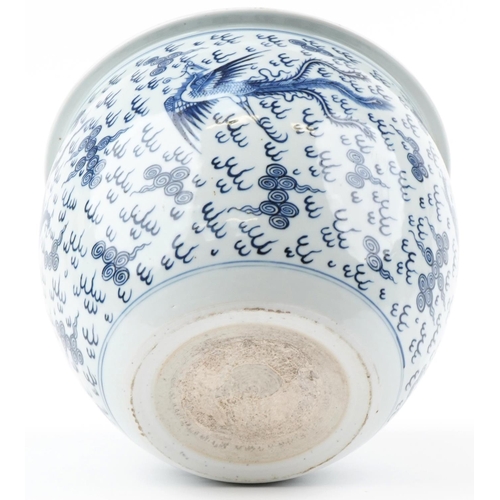 180 - A Chinese blue and white porcelain jardinière hand painted with dragons and phoenixes amongst clouds... 