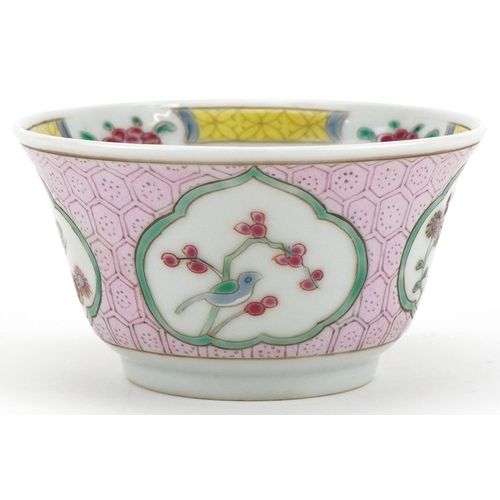 336 - A Chinese porcelain tea bowl and saucer hand painted with butterflies, flowers and birds on branches... 