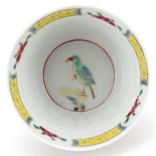 336 - A Chinese porcelain tea bowl and saucer hand painted with butterflies, flowers and birds on branches... 