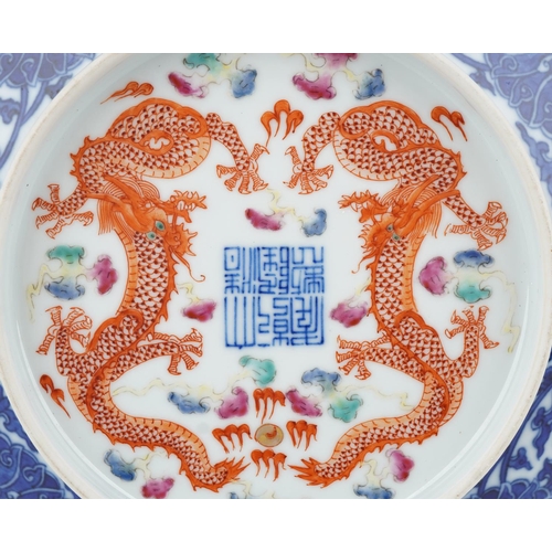 184 - A Chinese porcelain footed plate hand painted with dragons amongst clouds chasing the flaming pearl,... 