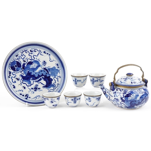 1421 - A Chinese blue and white porcelain teapot with six cups and circular tray hand painted with qilins, ... 