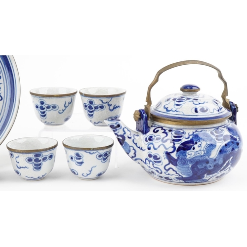 1421 - A Chinese blue and white porcelain teapot with six cups and circular tray hand painted with qilins, ... 