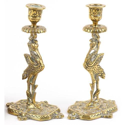 1423 - Two Chinese bronzed seated figures of Buddha and a pair of gilt brass candlesticks in the form of st... 