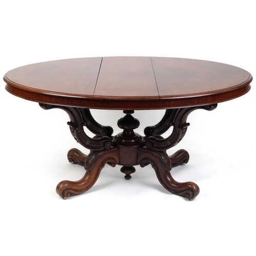 1123 - A late Victorian mahogany centre table, the oval top raised on carved supports and scroll legs, 72cm... 