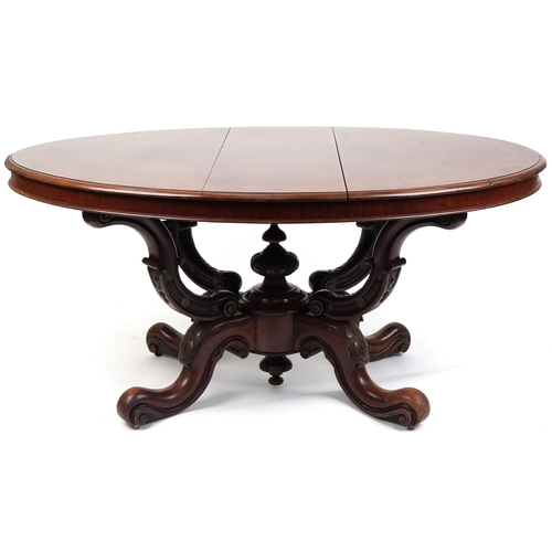 1123 - A late Victorian mahogany centre table, the oval top raised on carved supports and scroll legs, 72cm... 