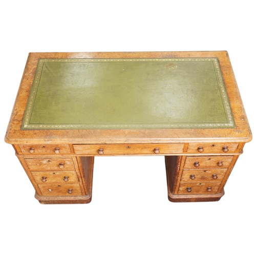 1005 - A Victorian oak twin pedestal desk by Hewetson & Milner, London, the moulded top inset with a green ... 