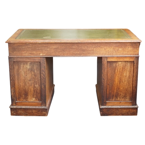 1005 - A Victorian oak twin pedestal desk by Hewetson & Milner, London, the moulded top inset with a green ... 