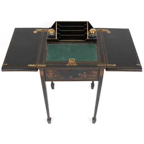 1001 - An Edwardian black chinoiserie lacquered metamorphic writing table, the double hinged lid revealing ... 