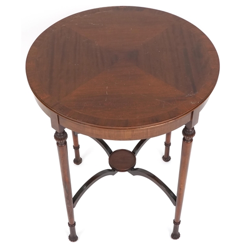 1077 - An Edwardian mahogany circular lamp table with line inlaid decoration raised on turned legs, the und... 