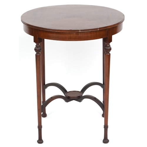 1077 - An Edwardian mahogany circular lamp table with line inlaid decoration raised on turned legs, the und... 