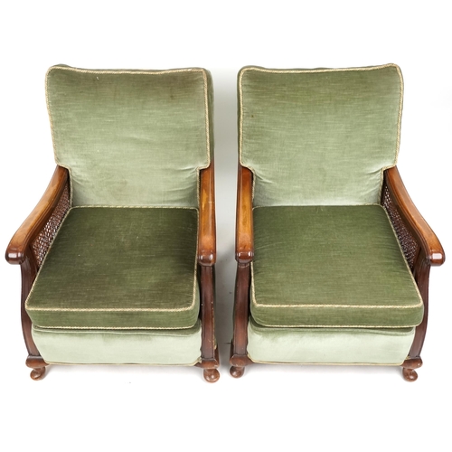 1072 - A George V three piece mahogany framed bergère suite upholstered in green velour comprising three se... 