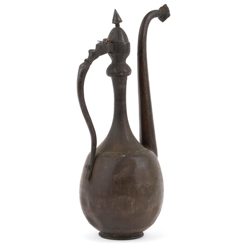 124 - A Turkish Ottoman brown patinated metal hot water jug, 19th century, with profusely engraved decorat... 