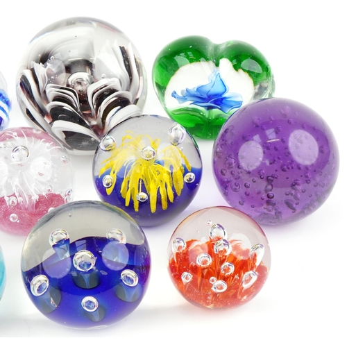 355A - Eleven late 20th century glass paperweights, the largest 10cm in diameter.