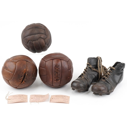 A group of three early 20th century leather footballs, circa 1920, 21cm in diameter, together with a pair of leather lace-up football boots, circa 1940, 29cm in length.