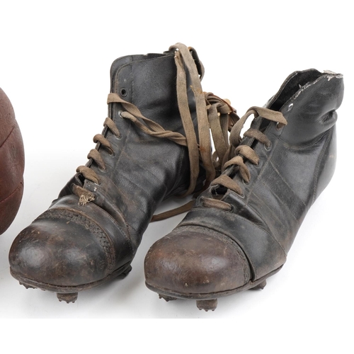  A group of three early 20th century leather footballs, circa 1920, 21cm in diameter, together with a... 