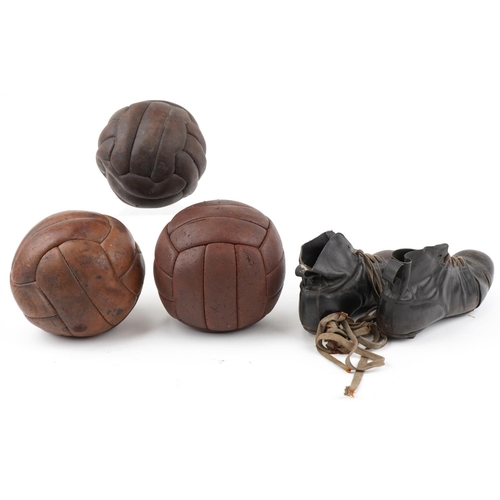  A group of three early 20th century leather footballs, circa 1920, 21cm in diameter, together with a... 