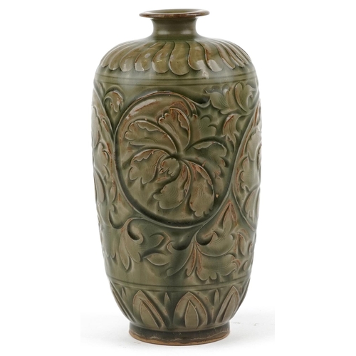 246 - A Chinese porcelain vase decorated in relief with foliage, 22cm high.