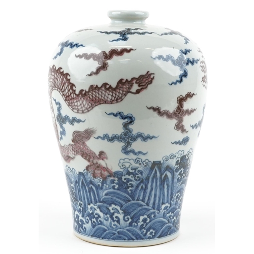 245 - A large Chinese porcelain baluster vase hand painted in iron red and blue with a dragon chasing the ... 