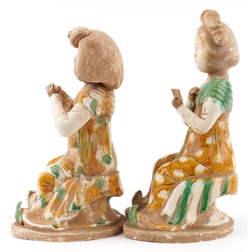 156 - A pair of Chinese Tang style pottery figures of females, the largest 38.5cm high.