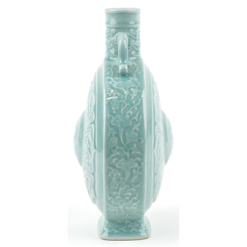 45 - A Chinese porcelain celadon glazed moon flask with twin handles relief decorated with foliage and ob... 