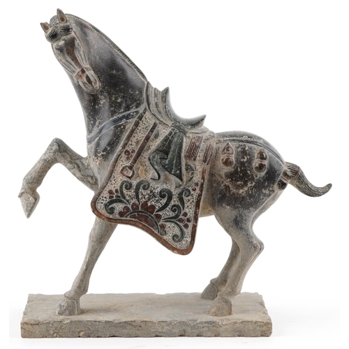 49 - A Chinese reconstituted carved hardstone study of a Tang horse having hand painted decoration, 37cm ... 