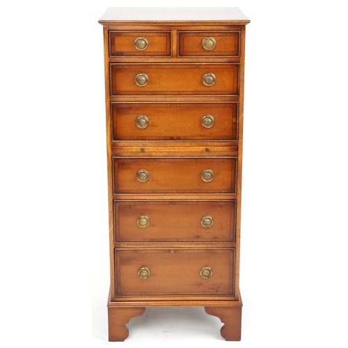 1063 - A late 20th century yew narrow chest of two short and five long drawers with a brushing slide, 116cm... 