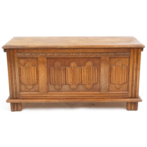 1065 - A late 20th century oak coffer with carved linen fold decoration, 47cm H x 94cm W x 38cm D.