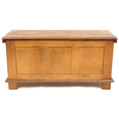 1065 - A late 20th century oak coffer with carved linen fold decoration, 47cm H x 94cm W x 38cm D.