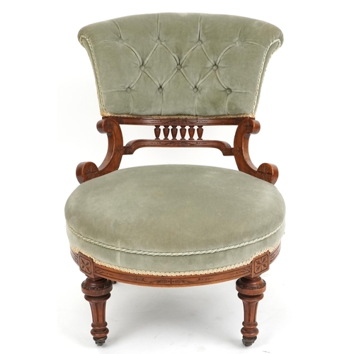 1103 - A late Victorian walnut framed nursing chair upholstered in green velour, 72cm H x 58cm W x 73cm D.