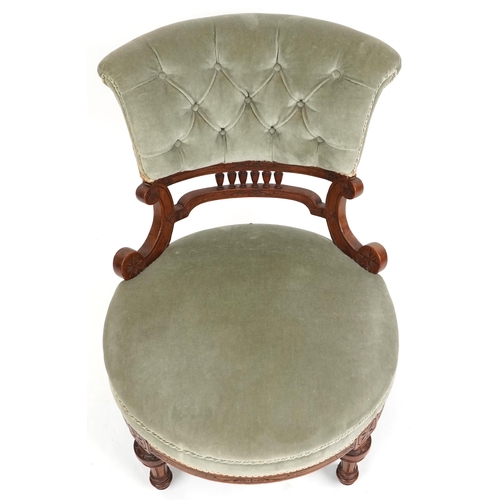 1103 - A late Victorian walnut framed nursing chair upholstered in green velour, 72cm H x 58cm W x 73cm D.